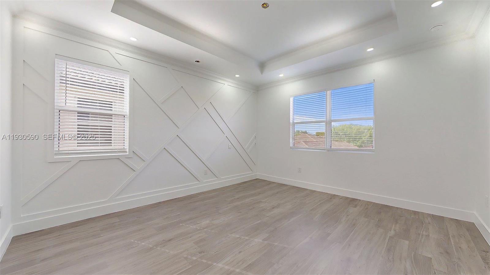 25324 Southwest 119th Avenue Homestead, FL 33032 - Photo 31 of 41 an empty room with wooden floor and windows