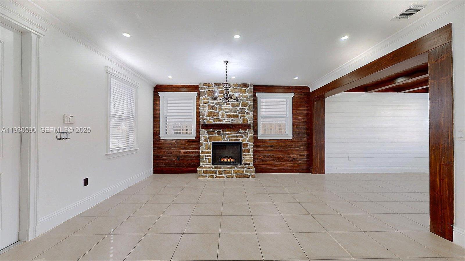 25324 Southwest 119th Avenue Homestead, FL 33032 - Photo 5 of 41 a view of an empty room with a fireplace