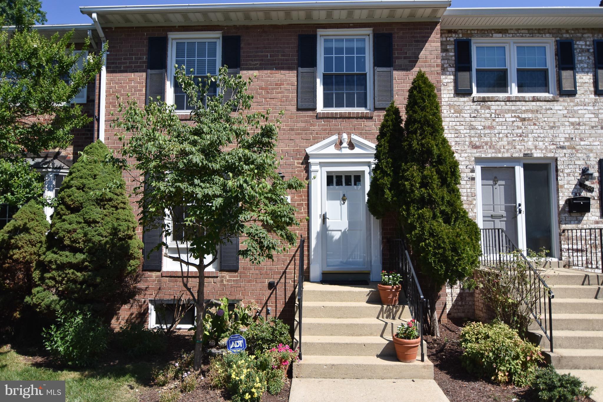 3302 Spring Lane Falls Church, VA 22041 - Photo 1 of 30 a view of a house with brick walls and flower plants
