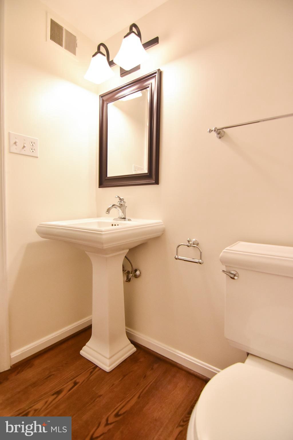 3302 Spring Lane Falls Church, VA 22041 - Photo 6 of 30 a bathroom with a sink mirror vanity and toilet
