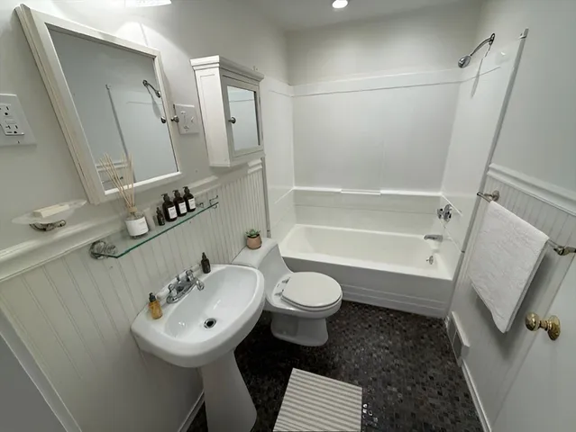 a bathroom with a sink toilet and shower