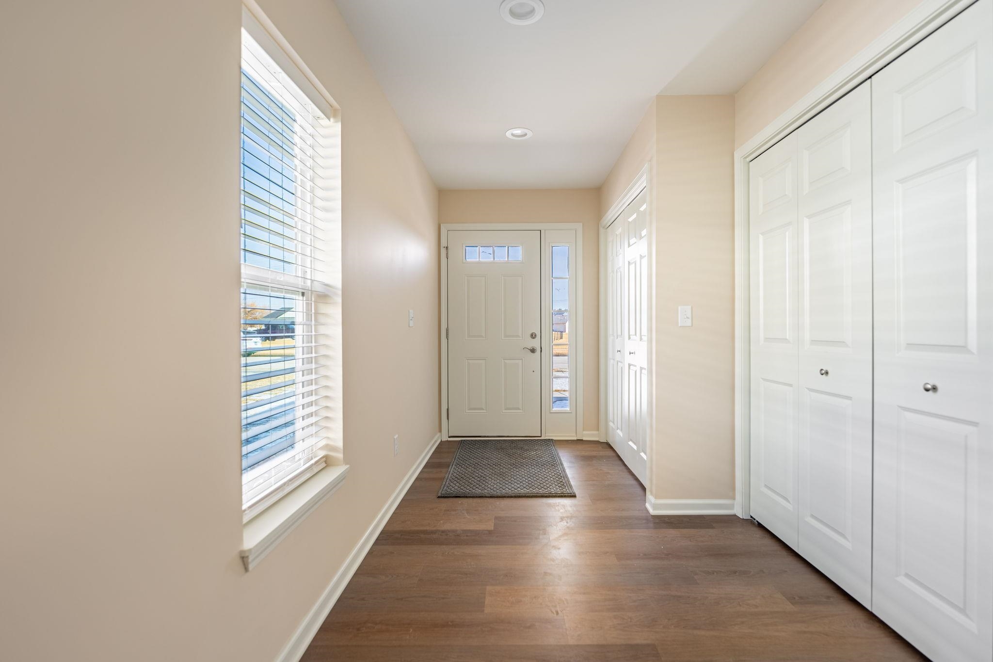 898 Fuller Lane Belvidere, IL 61008 - Photo 2 of 29 a view of a hallway with wooden floor and staircase