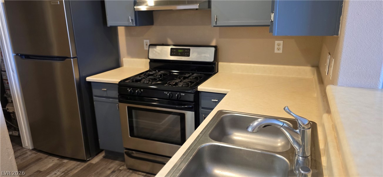 1830 North Pecos Road, Unit 142 Las Vegas, NV 89115 - Photo 12 of 19 A compact kitchen with stainless steel appliances and ample counter space for daily culinary tasks.