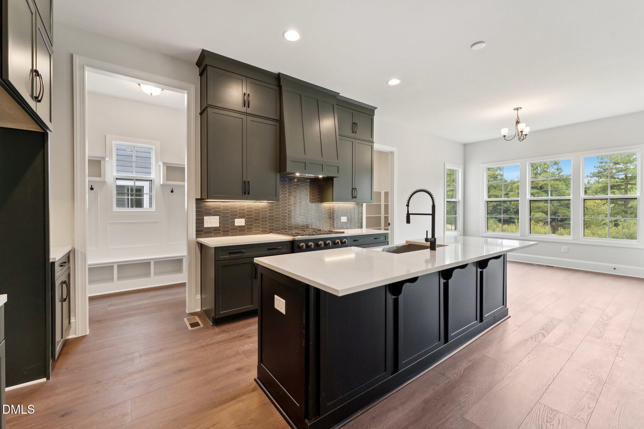 269 Ridge Road Chapel Hill, NC 27516 - Photo 14 of 41 a kitchen with kitchen island granite countertop a sink stove and cabinets