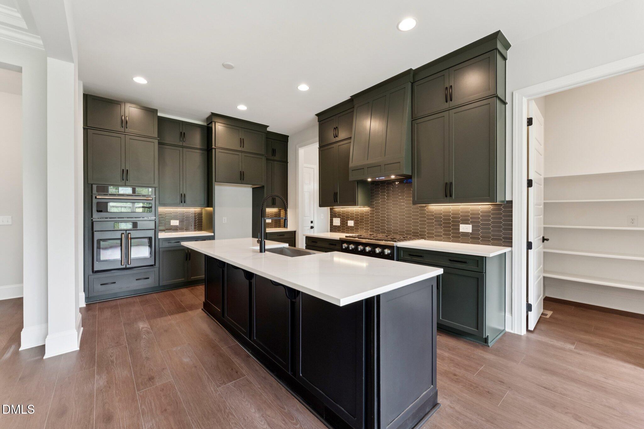 269 Ridge Road Chapel Hill, NC 27516 - Photo 15 of 41 a kitchen with kitchen island granite countertop a sink appliances and cabinets