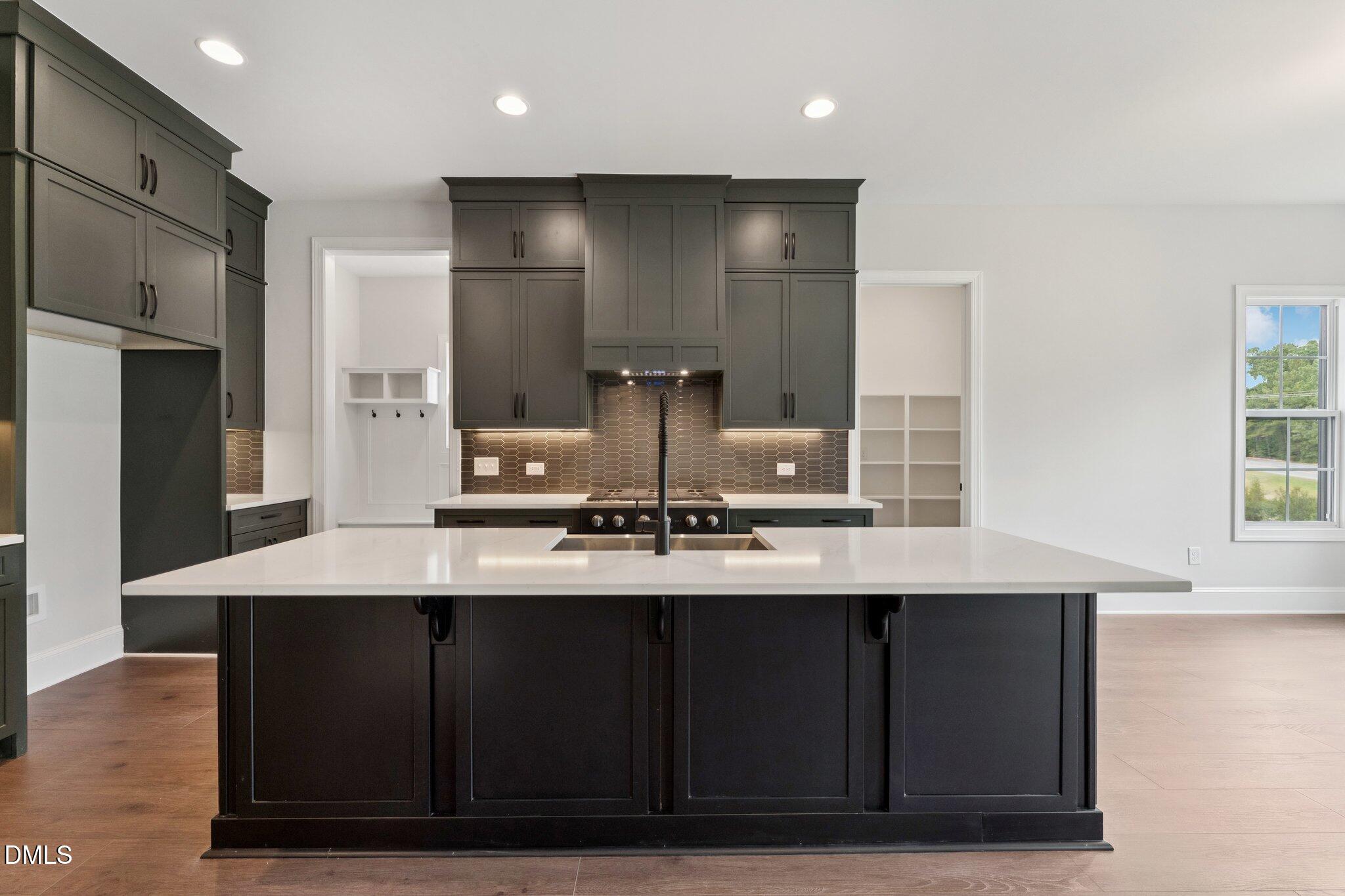 269 Ridge Road Chapel Hill, NC 27516 - Photo 20 of 41 a kitchen with kitchen island granite countertop a sink cabinets and stainless steel appliances