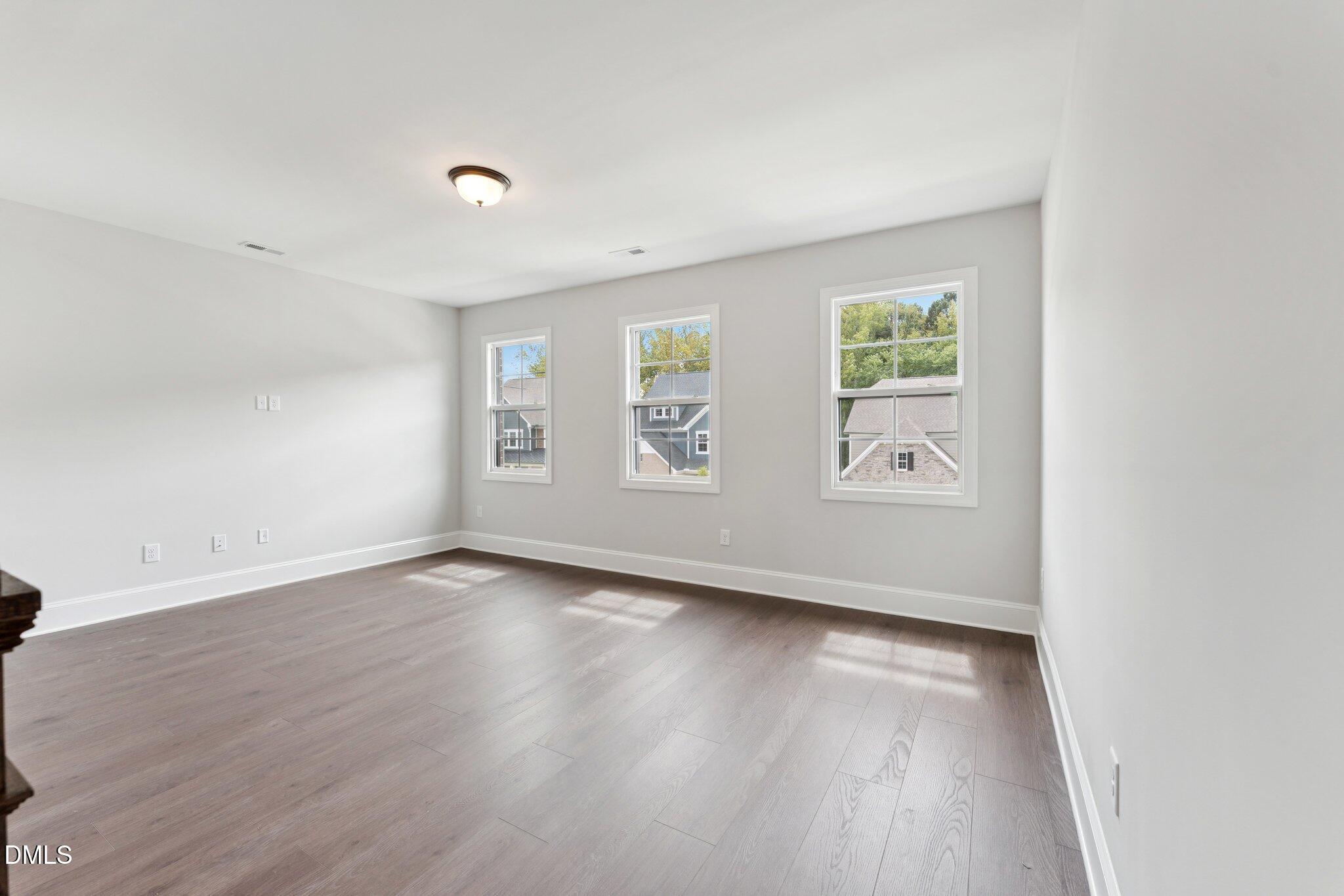 269 Ridge Road Chapel Hill, NC 27516 - Photo 26 of 41 an empty room with wooden floor and windows
