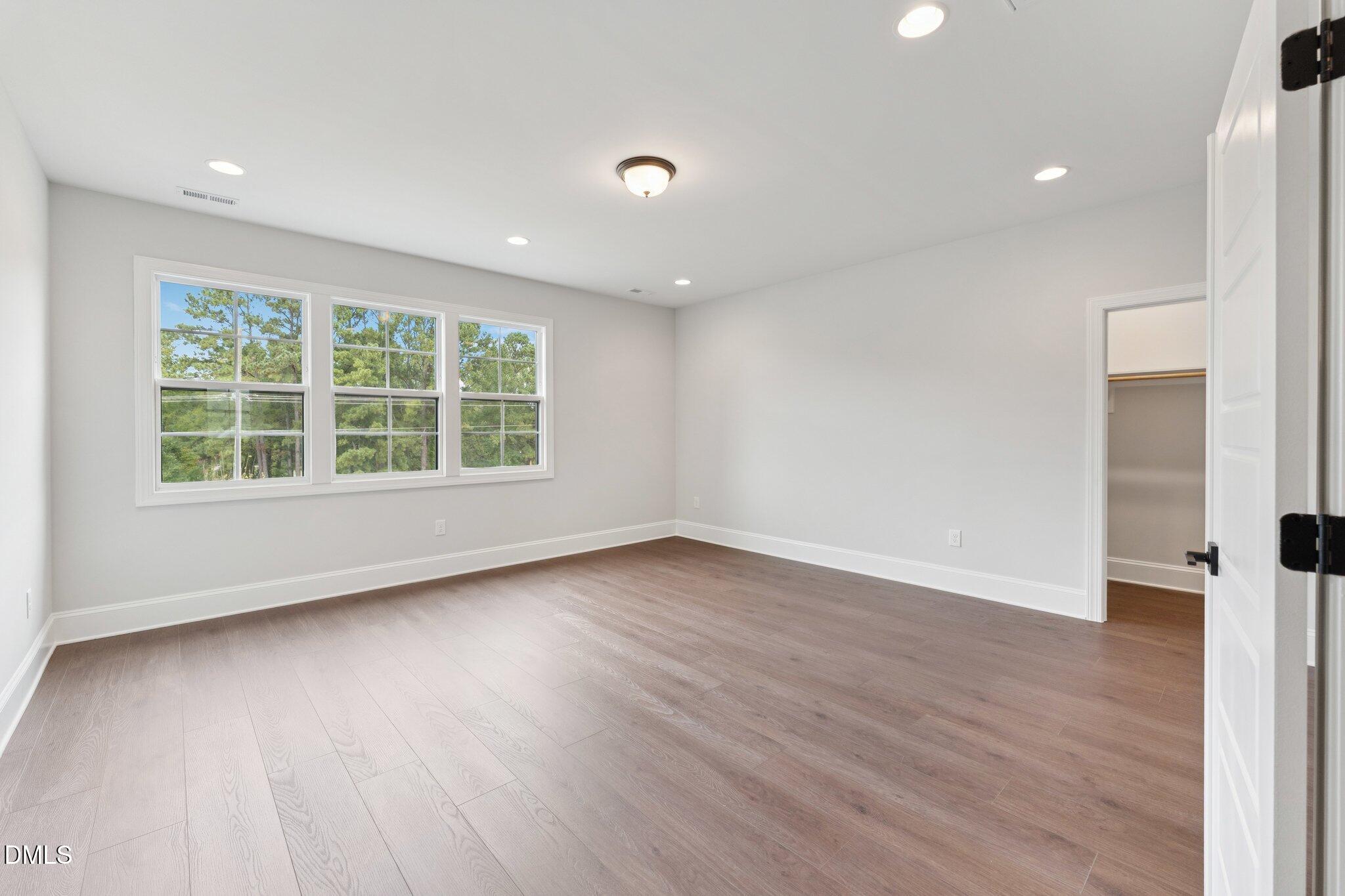269 Ridge Road Chapel Hill, NC 27516 - Photo 28 of 41 an empty room with wooden floor and windows