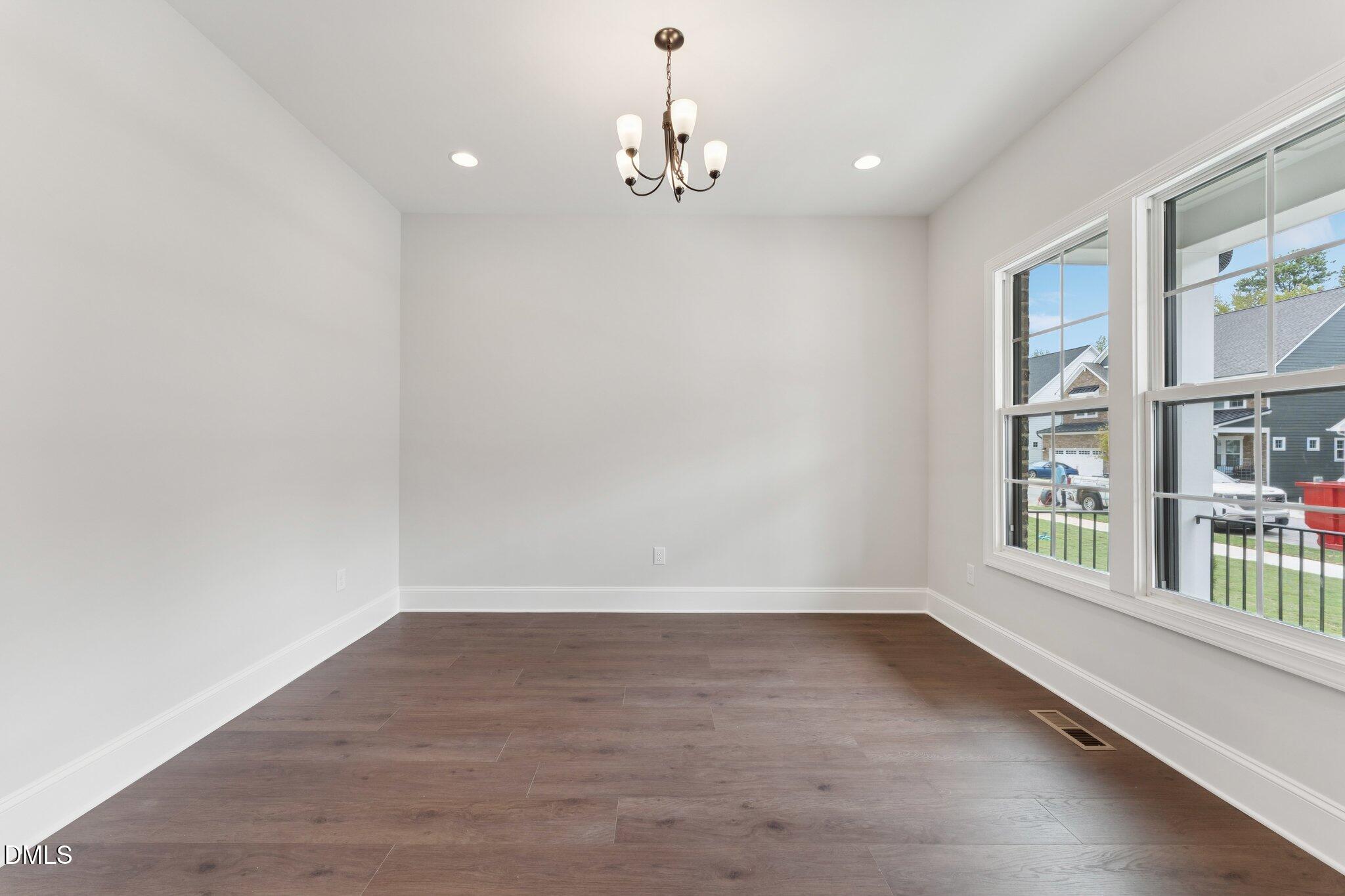 269 Ridge Road Chapel Hill, NC 27516 - Photo 3 of 41 wooden floor in an empty room with a window