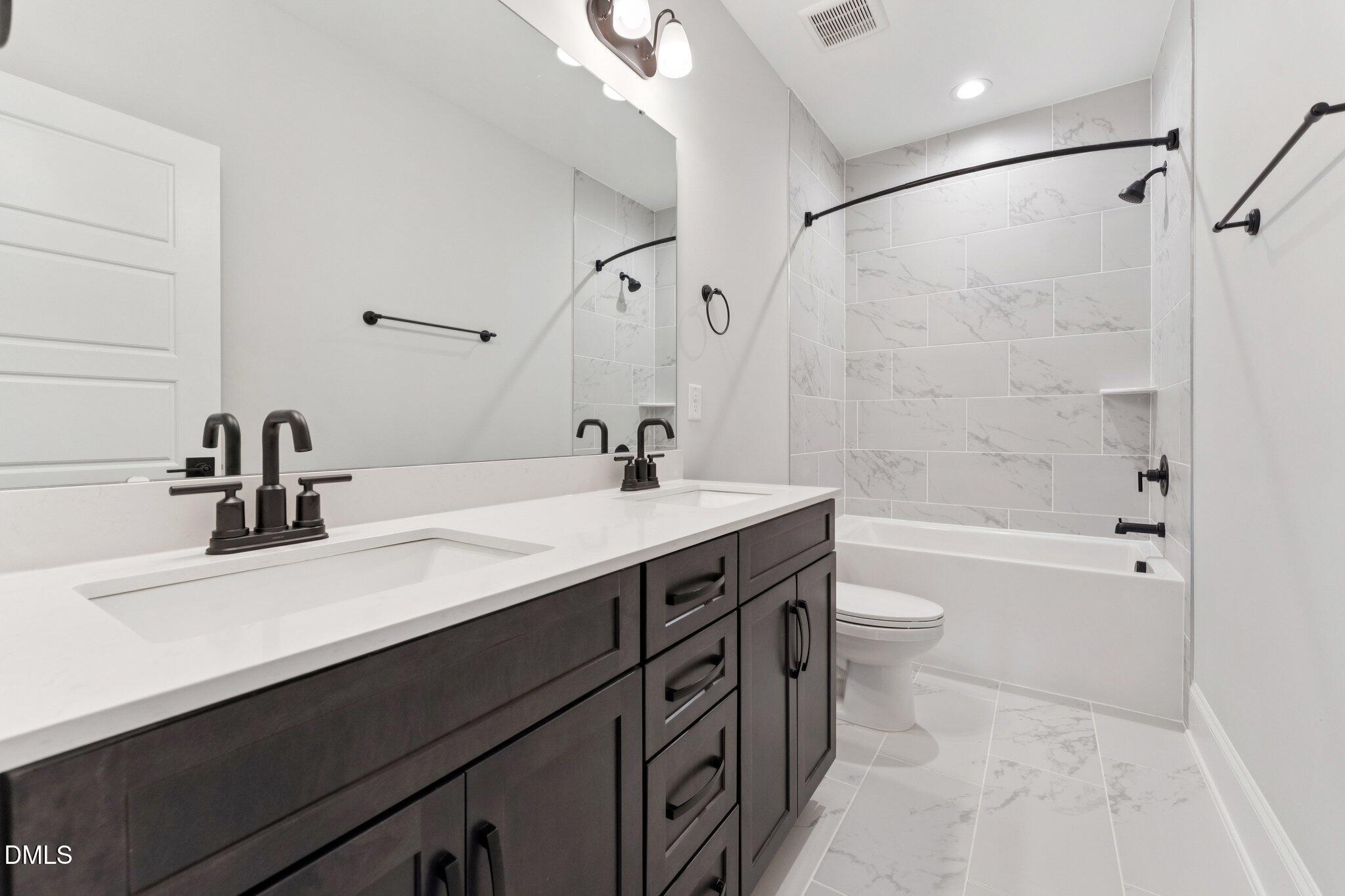 269 Ridge Road Chapel Hill, NC 27516 - Photo 34 of 41 a bathroom with a bathtub shower sink vanity mirror and toilet