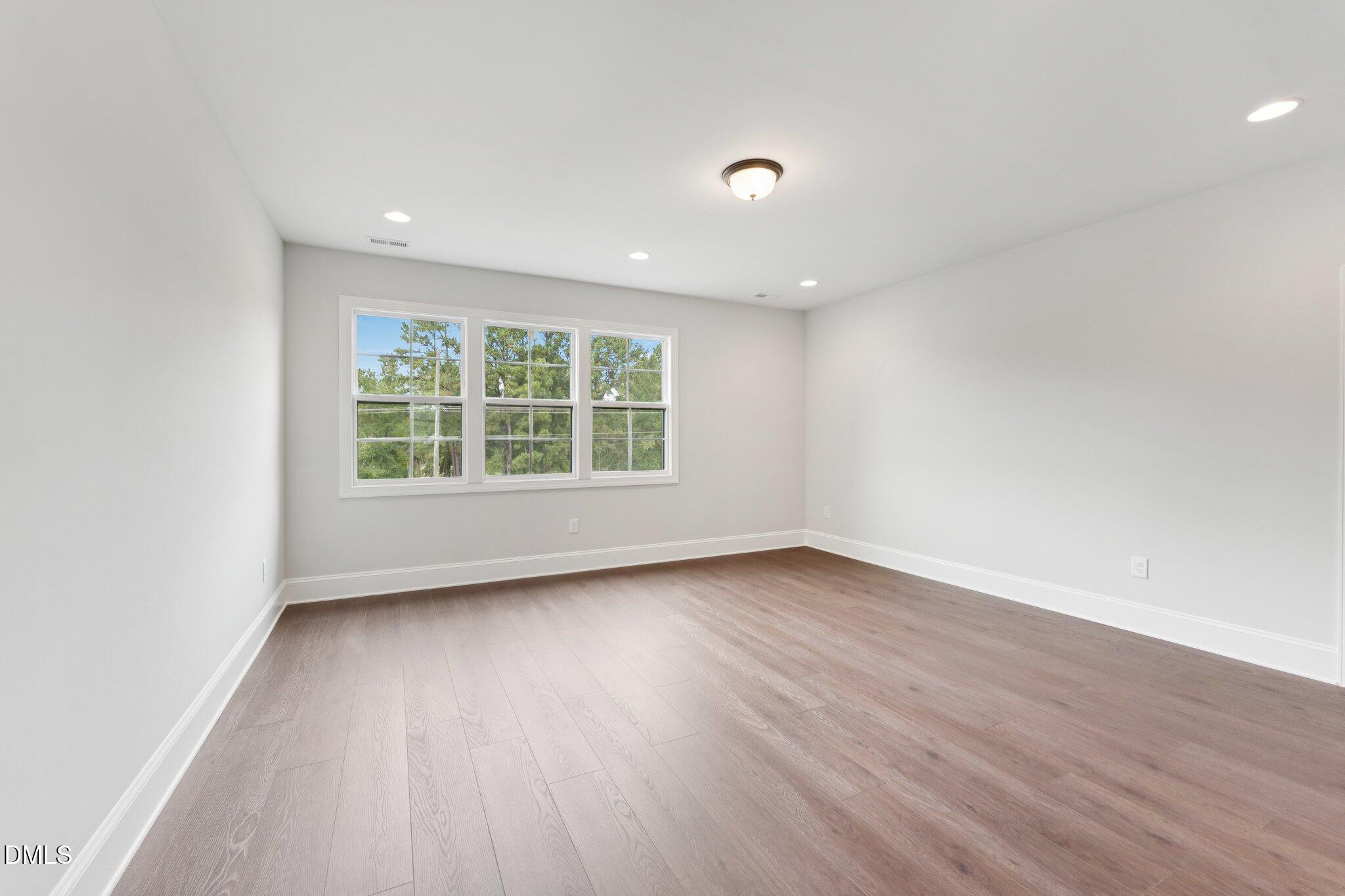 269 Ridge Road Chapel Hill, NC 27516 - Photo 35 of 41 an empty room with wooden floor and windows