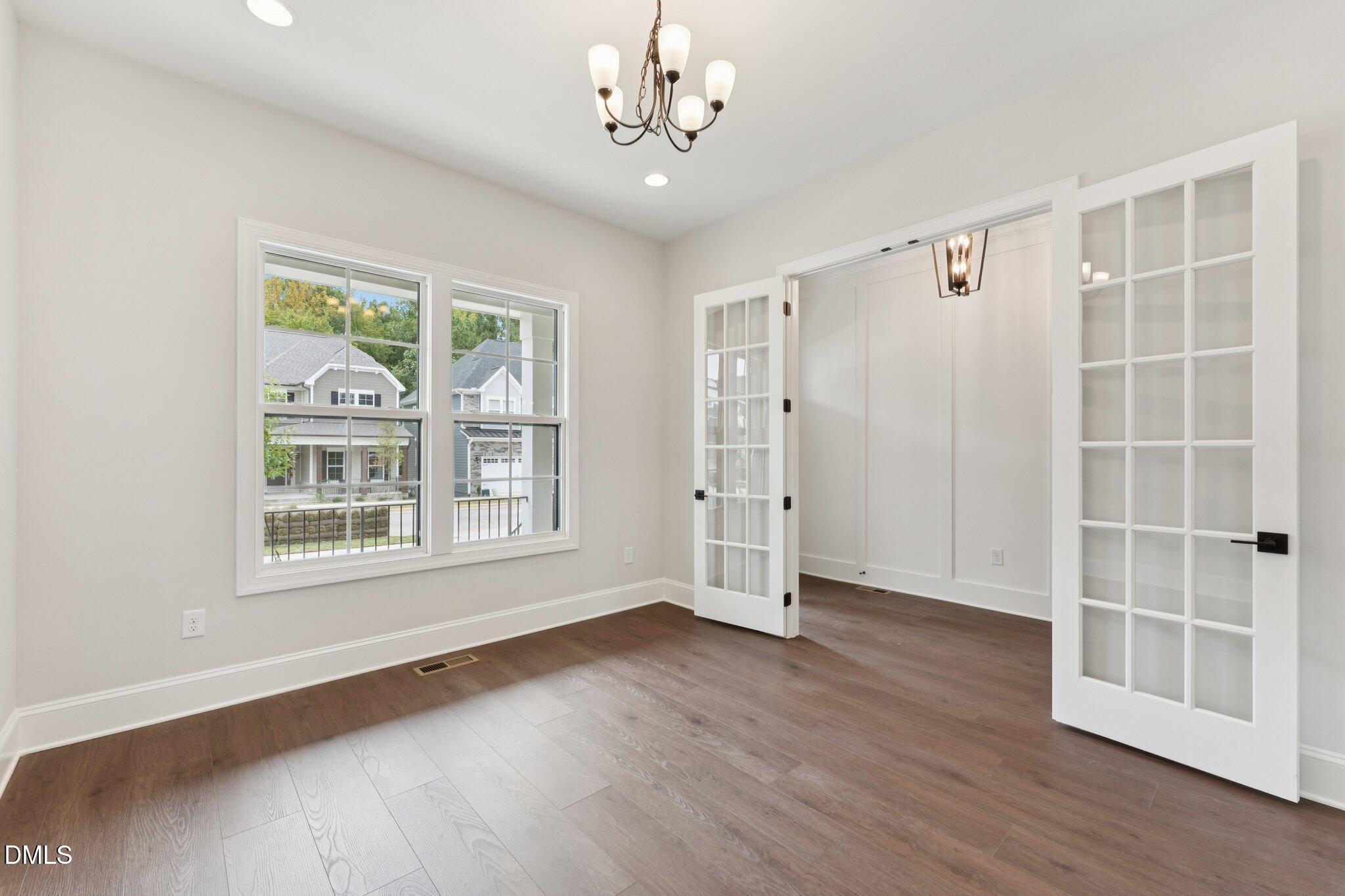 269 Ridge Road Chapel Hill, NC 27516 - Photo 4 of 41 a view of an empty room with a window and wooden floor