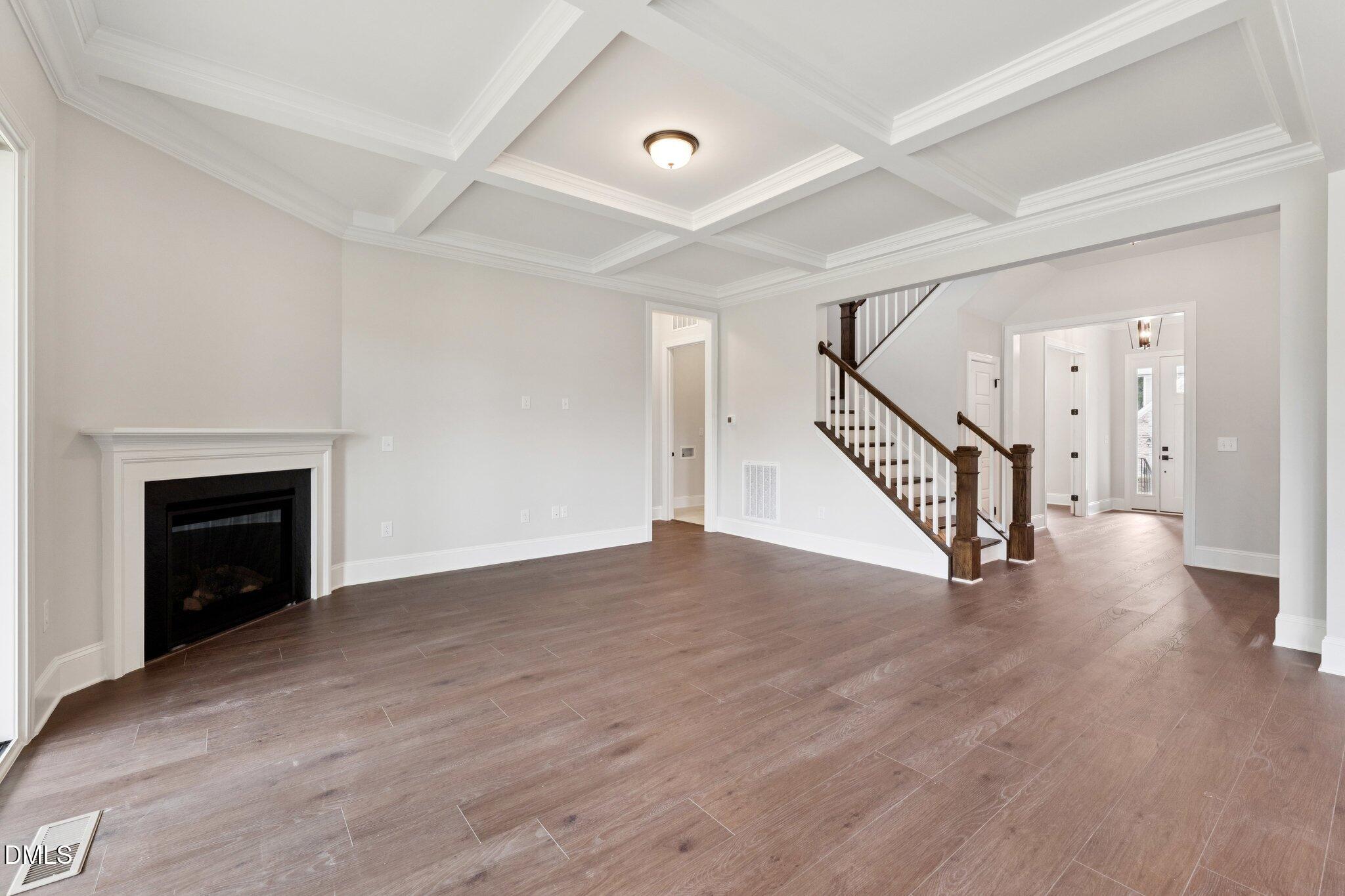 269 Ridge Road Chapel Hill, NC 27516 - Photo 7 of 41 a view of an empty room with wooden floor fireplace and a window