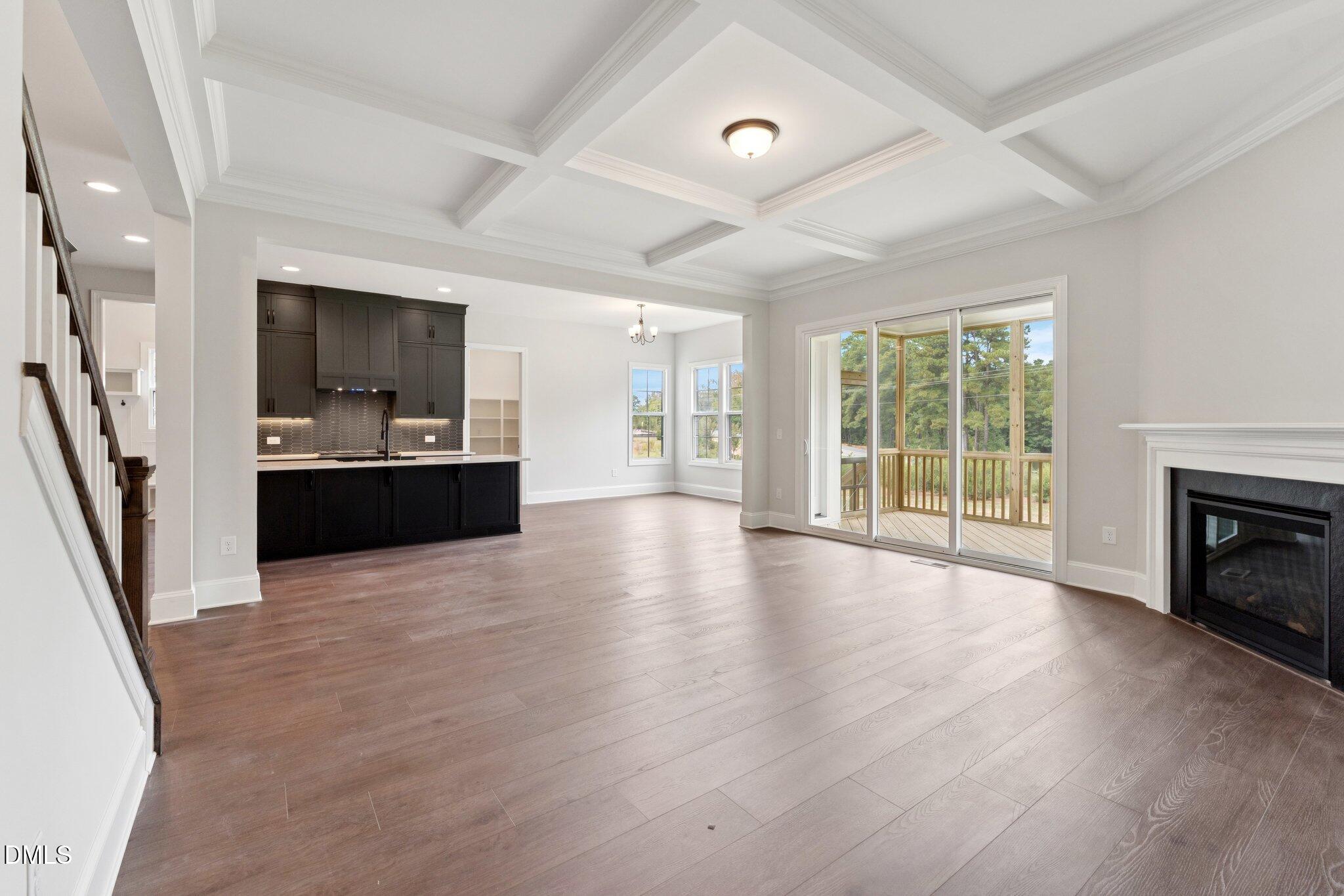 269 Ridge Road Chapel Hill, NC 27516 - Photo 8 of 41 an empty room with wooden floor and fireplace