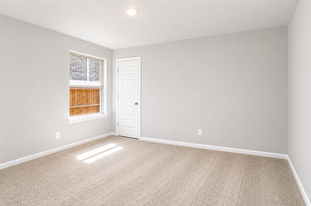 3344 Duncan Way Corinth, TX 76210 - Photo 22 of 38 Neutral-toned interior room featuring light gray walls and beige carpet flooring