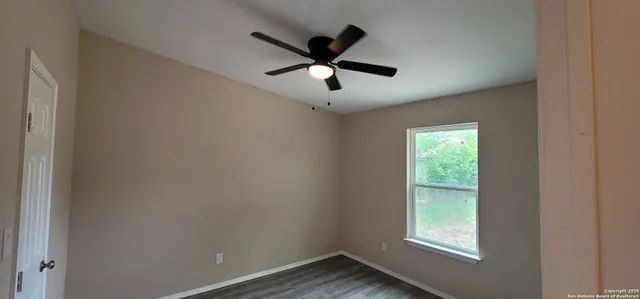 a view of empty room with ceiling fan