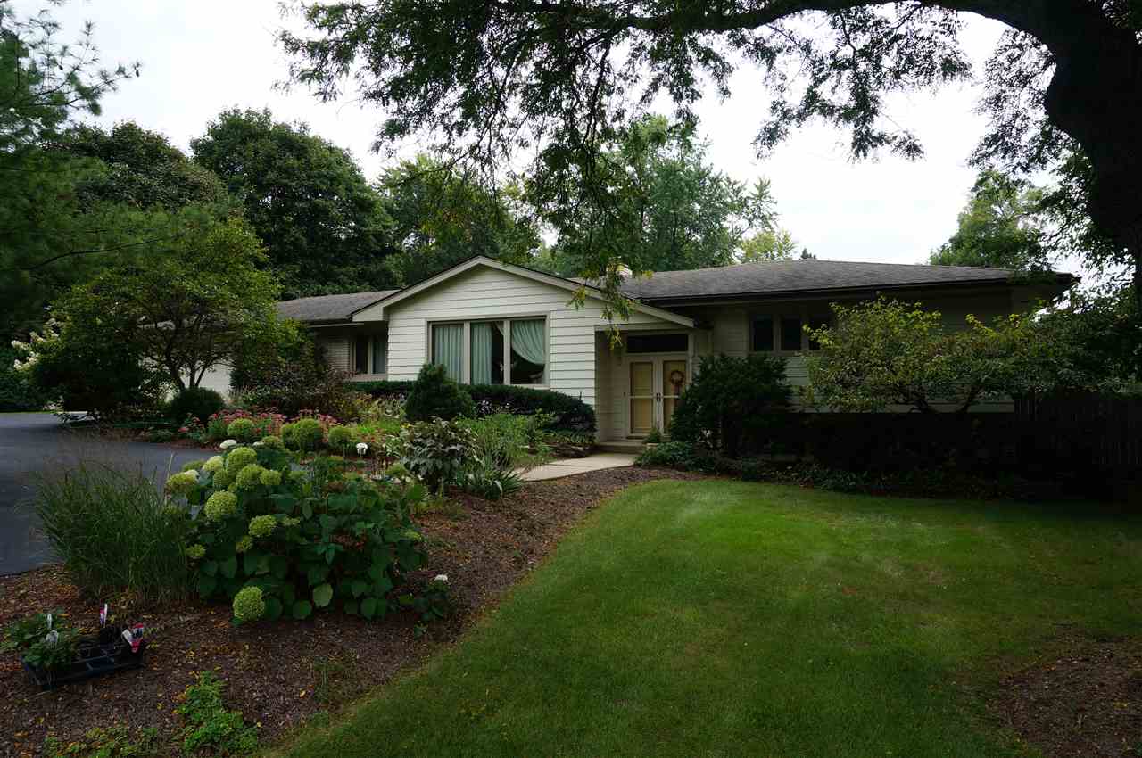 4615 Spring Creek Road Rockford, IL 61107 - Photo 1 of 14 a front view of a house with a yard