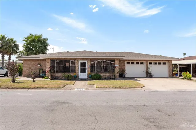 a front view of a house with a yard and a garage