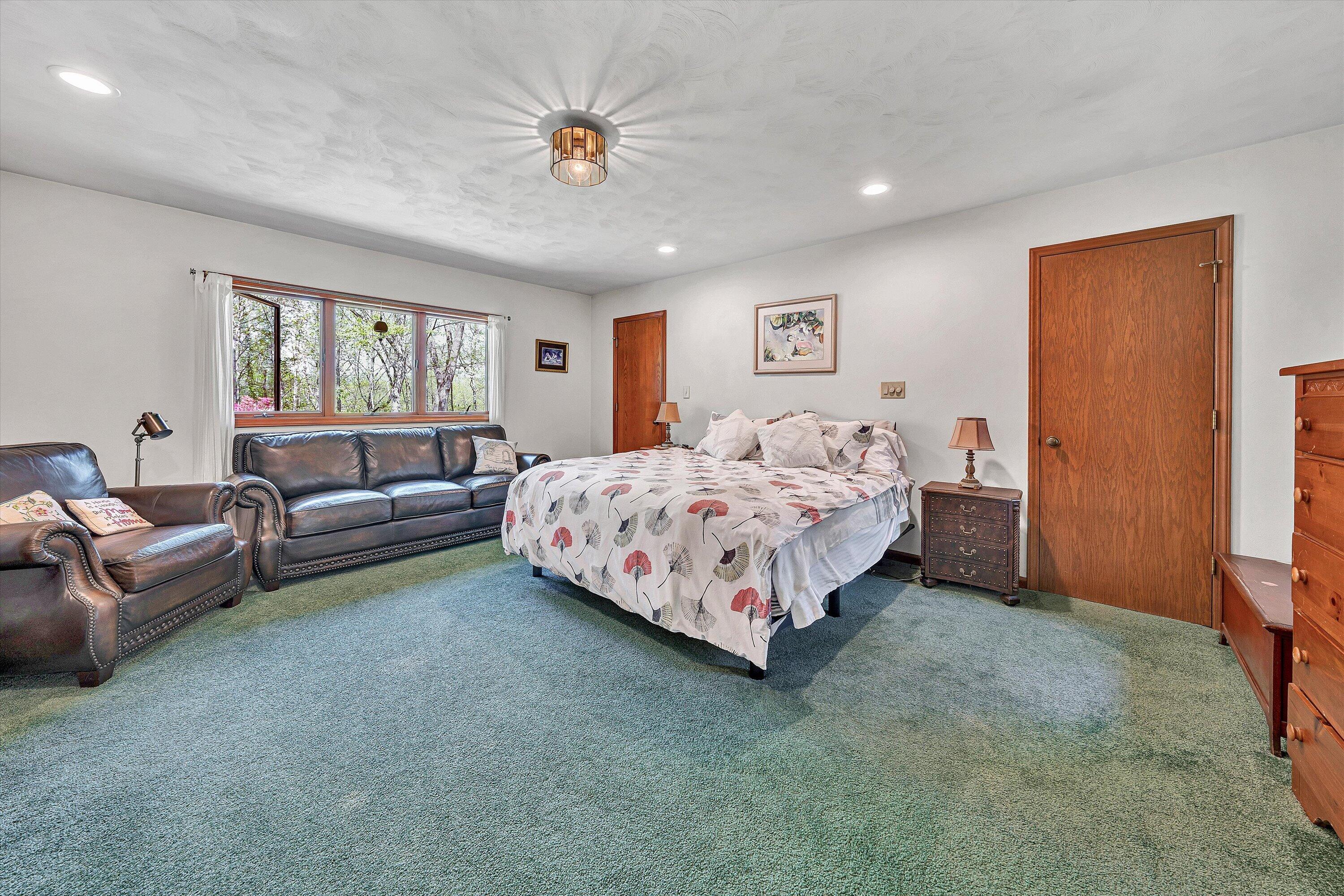 1124 Old Hollow Road Buchanan, VA 24066 - Photo 30 of 73 a spacious bedroom with a bed a couch and a window