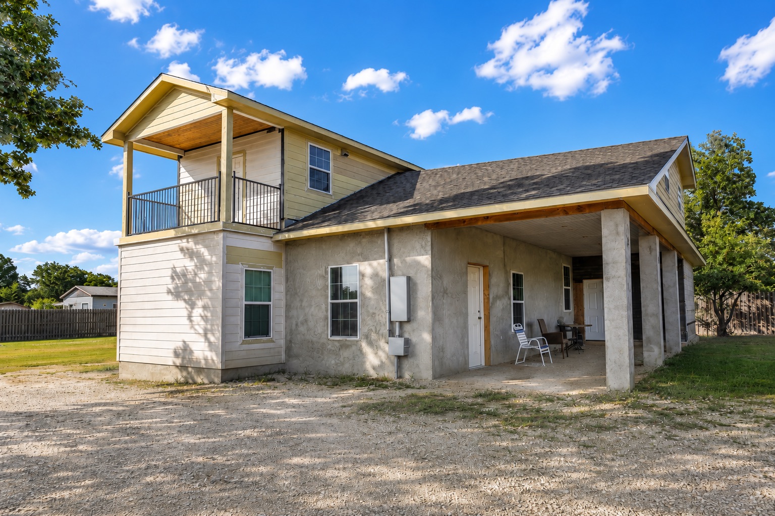 158 Buena Fortuna Road Elgin, TX 78621 - Photo 3 of 40 A spacious home with a covered front porch and an upper-level balcony offers abundant outdoor living space.