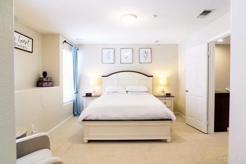 2232 Huntington Point Road, Unit 53 Chula Vista, CA 91914 - Photo 21 of 37 a bedroom with a bed and a couch