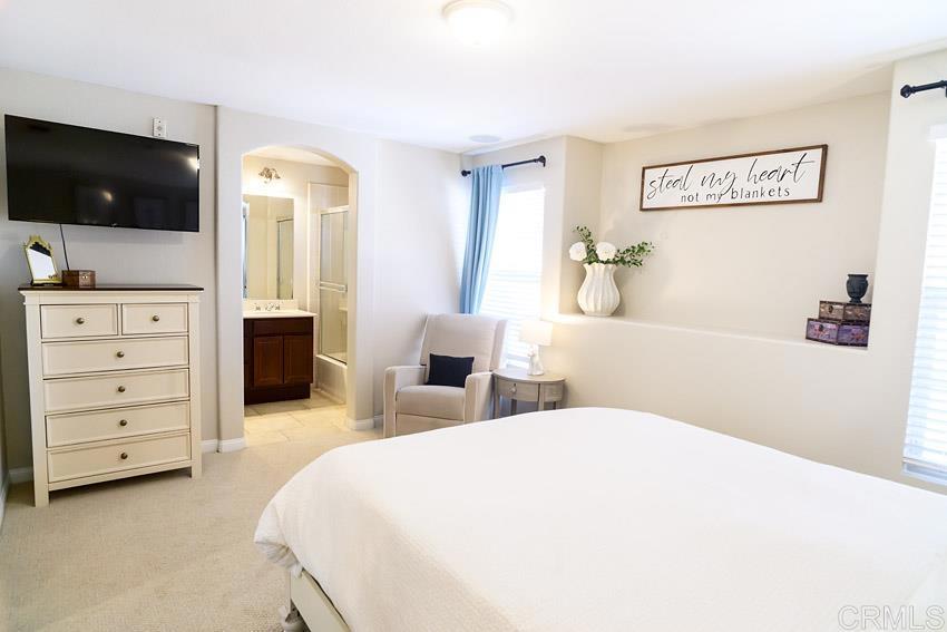 2232 Huntington Point Road, Unit 53 Chula Vista, CA 91914 - Photo 22 of 37 a spacious bedroom with a bed and a flat screen tv