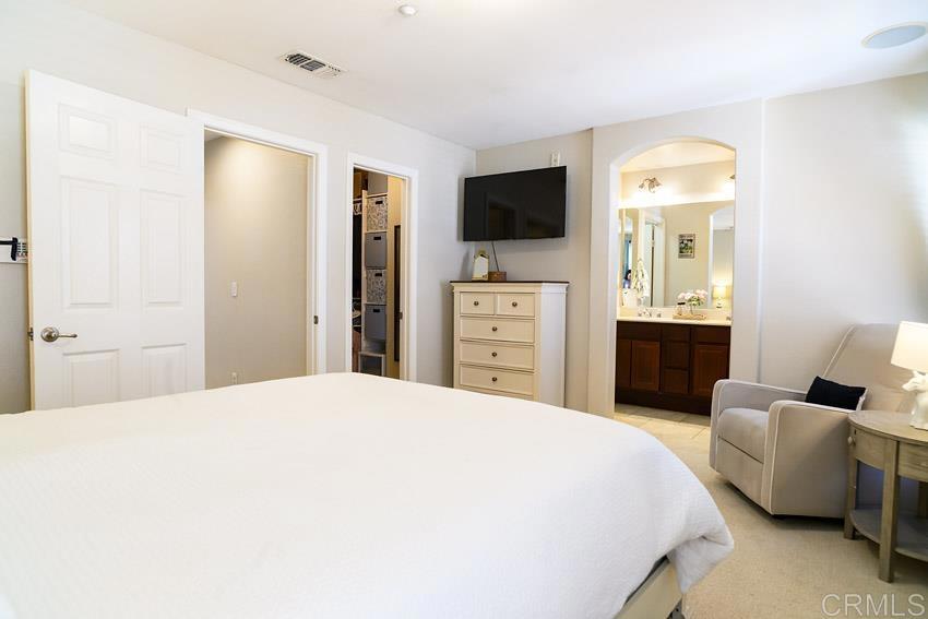 2232 Huntington Point Road, Unit 53 Chula Vista, CA 91914 - Photo 24 of 37 a bedroom with a bed and a flat screen tv