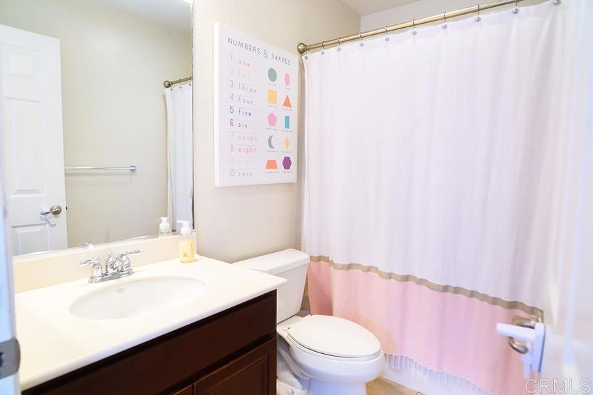 2232 Huntington Point Road, Unit 53 Chula Vista, CA 91914 - Photo 29 of 37 a bathroom with a sink a toilet and shower curtain