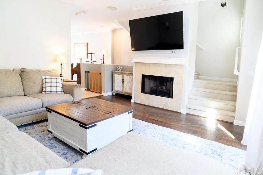 2232 Huntington Point Road, Unit 53 Chula Vista, CA 91914 - Photo 3 of 37 a living room with furniture a flat screen tv and a fireplace