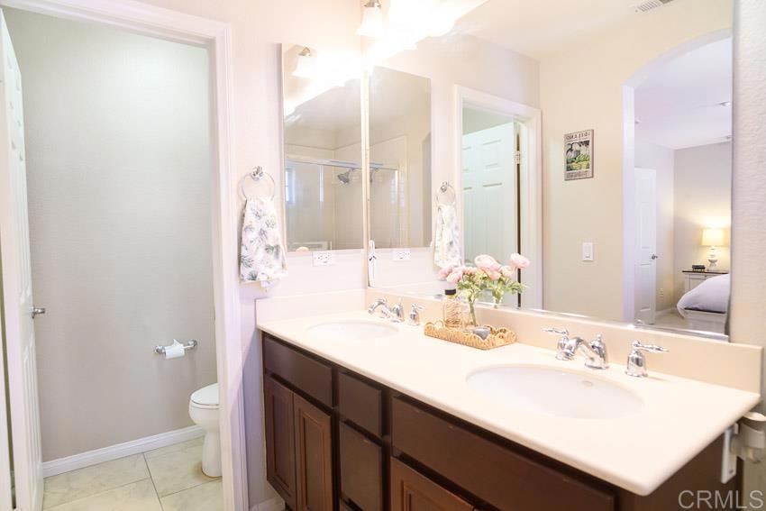 2232 Huntington Point Road, Unit 53 Chula Vista, CA 91914 - Photo 31 of 37 a bathroom with a sink a toilet and a mirror
