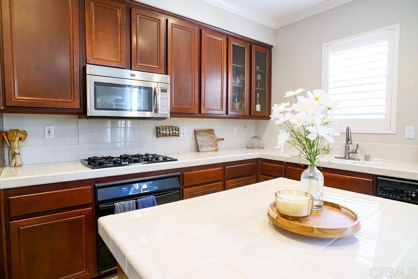 2232 Huntington Point Road, Unit 53 Chula Vista, CA 91914 - Photo 5 of 37 a kitchen with stainless steel appliances granite countertop a sink a stove and a microwave