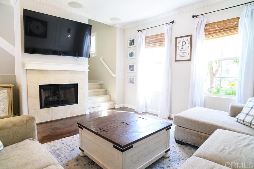 2232 Huntington Point Road, Unit 53 Chula Vista, CA 91914 - Photo 7 of 37 a living room with furniture a flat screen tv and a fireplace