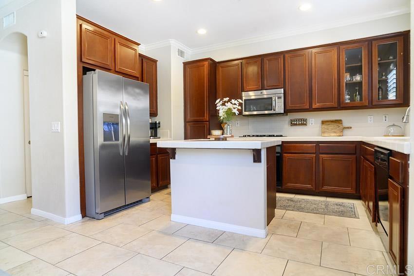 2232 Huntington Point Road, Unit 53 Chula Vista, CA 91914 - Photo 10 of 37 a kitchen with stainless steel appliances granite countertop a stove a refrigerator and a sink