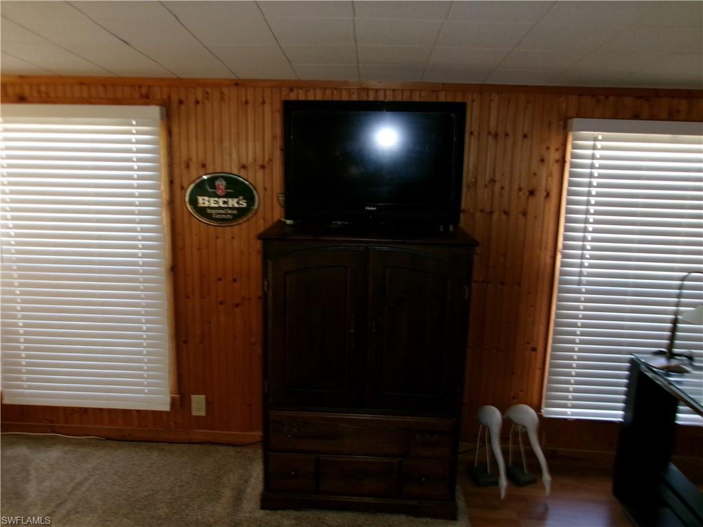 2 Monaco Terrace Naples, FL 34112 - Photo 8 of 24 Living area featuring wood walls