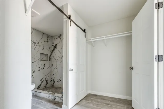 a bathroom with a glass shower door