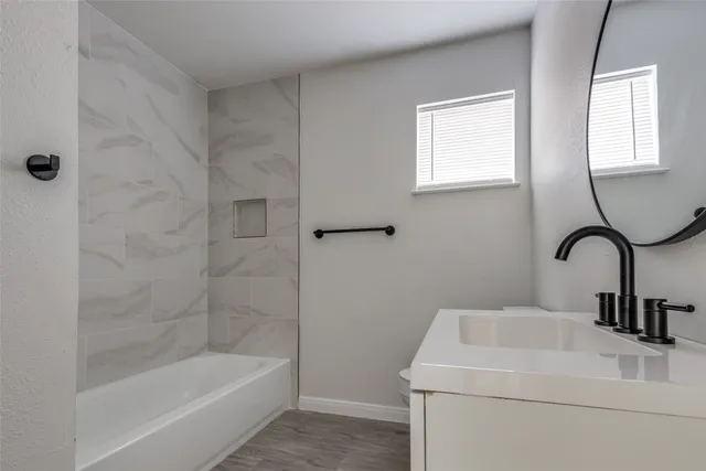 a bathroom with a sink a bathtub and a shower