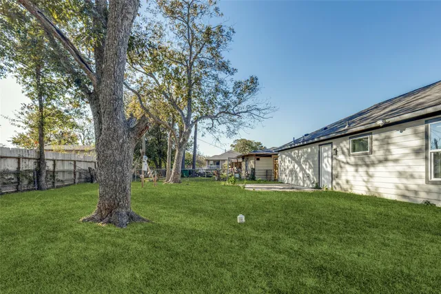 a view of a backyard with large trees