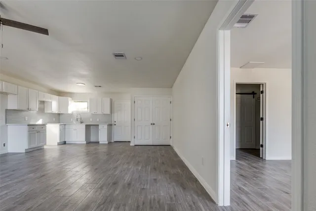 a view of a kitchen with a sink and a refrigerator