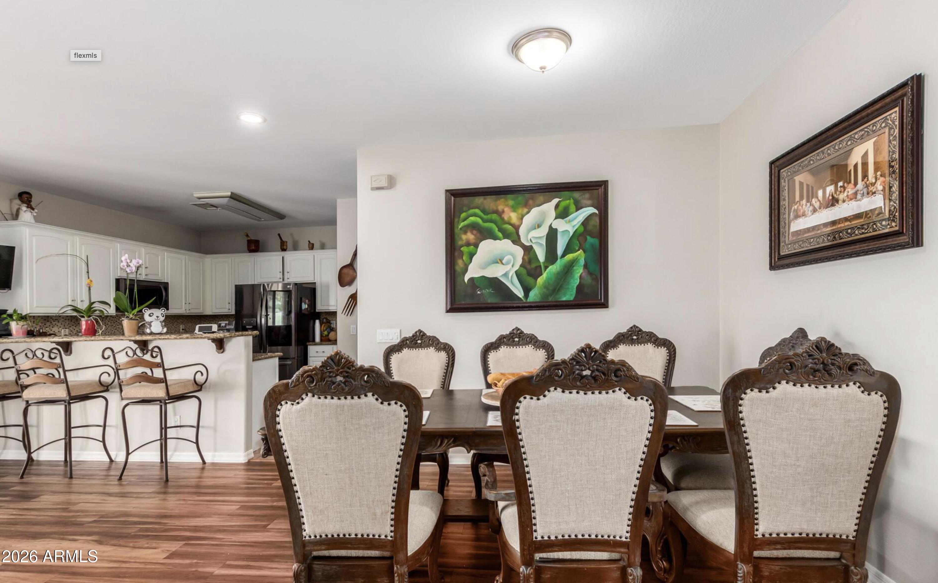 10225 West Camelback Road, Unit 12 Phoenix, AZ 85037 - Photo 7 of 19 a view of a dining room with furniture and wooden floor