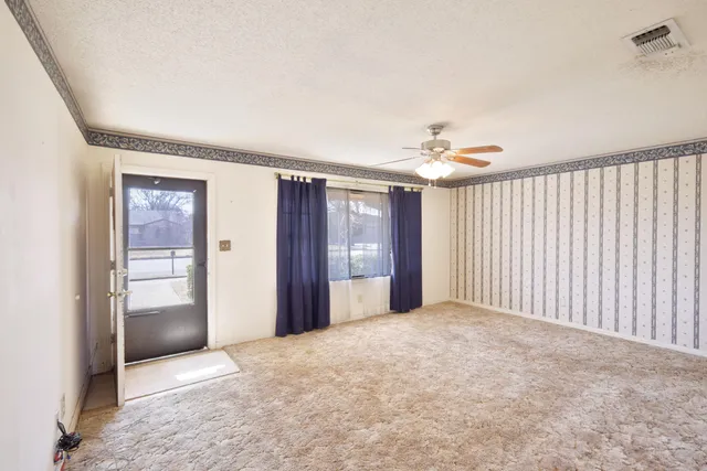 a view of an empty room with a window