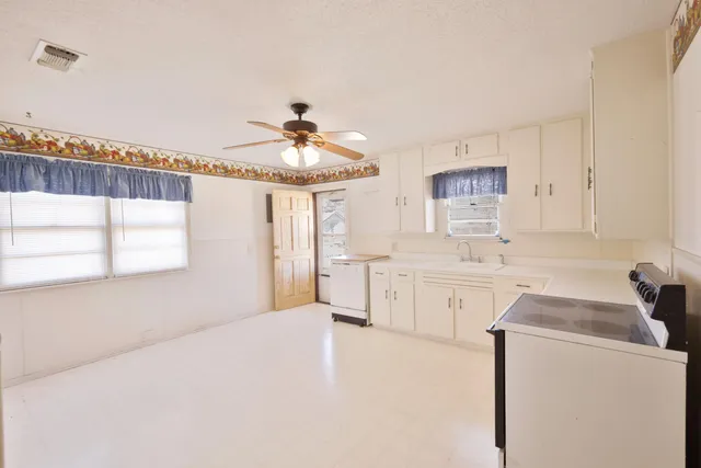 a kitchen with a refrigerator and a stove