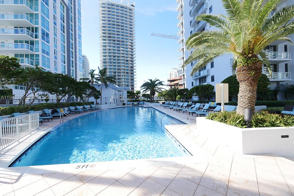 1050 Brickell Avenue, Unit 3206 Miami, FL 33131 - Photo 12 of 13 a view of swimming pool with outdoor seating