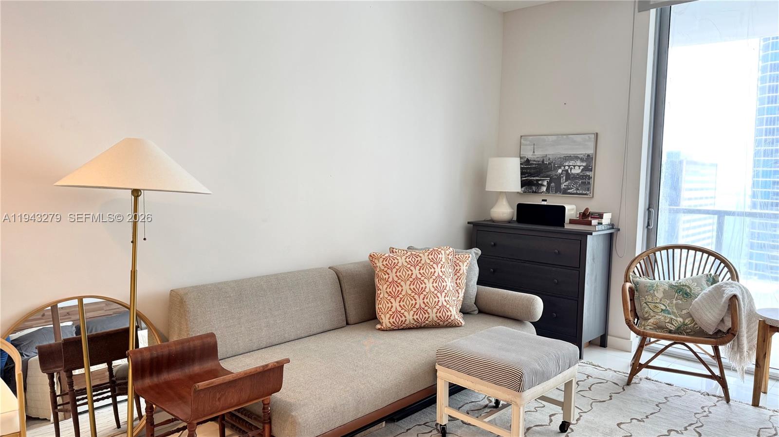 1050 Brickell Avenue, Unit 3206 Miami, FL 33131 - Photo 2 of 13 a living room with furniture and a lamp