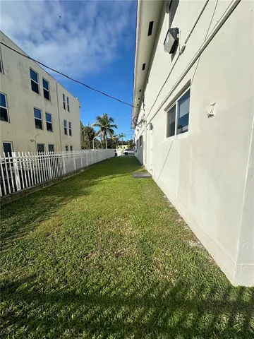 a view of a house with a wooden fence