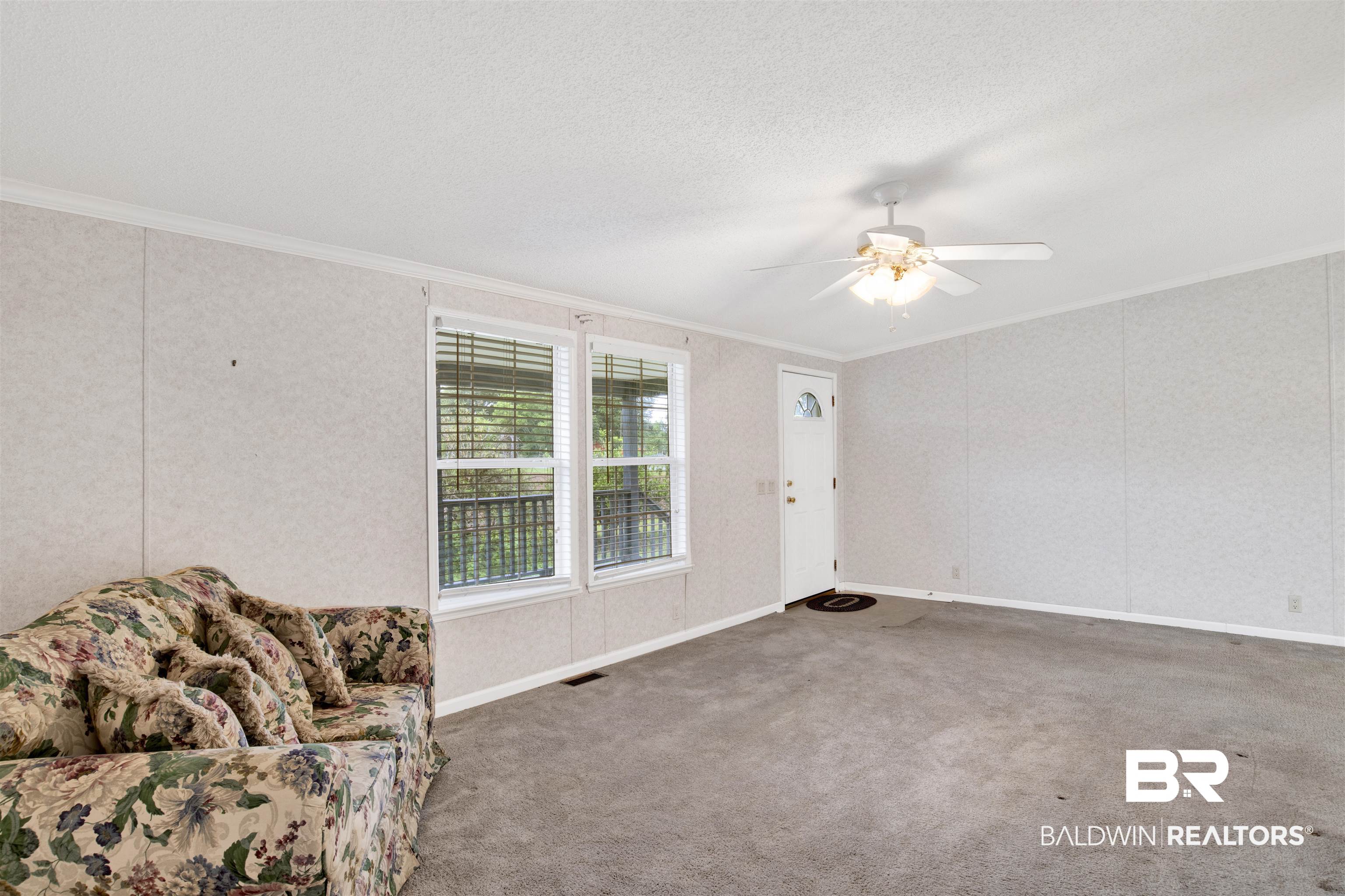 25700 County Road 71 Robertsdale, AL 36567 - Photo 5 of 40 Interior space with crown molding, ceiling fan, and carpet flooring