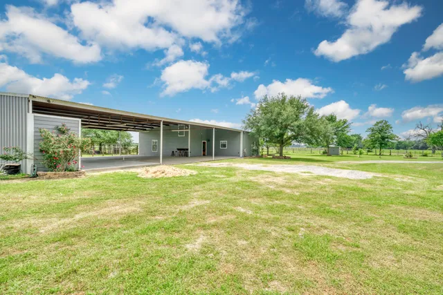 a view of a house with a backyard