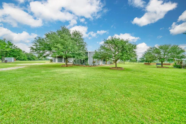 a view of grassy field with benches