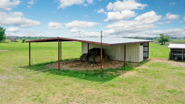 a backyard of a house with plants and outdoor seating