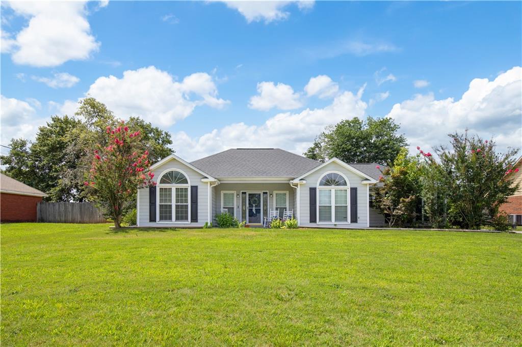 87 Lee Road Phenix City, AL 36867 - Photo 1 of 31 Light gray siding exterior with dark shutters and an arched window accent