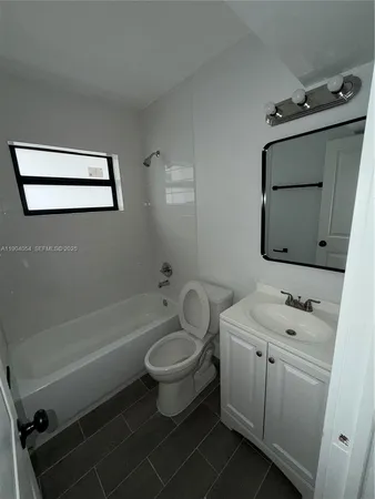a bathroom with a sink toilet a mirror and vanity